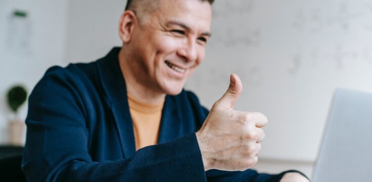 man-giving-thumbs-up-to-laptop