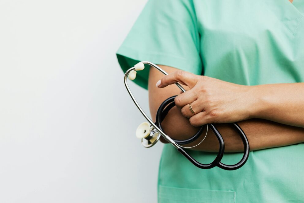 Medical Assistant with arms crossed holding stethoscope